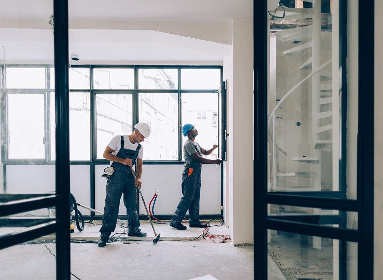Construction workers renovating interior space