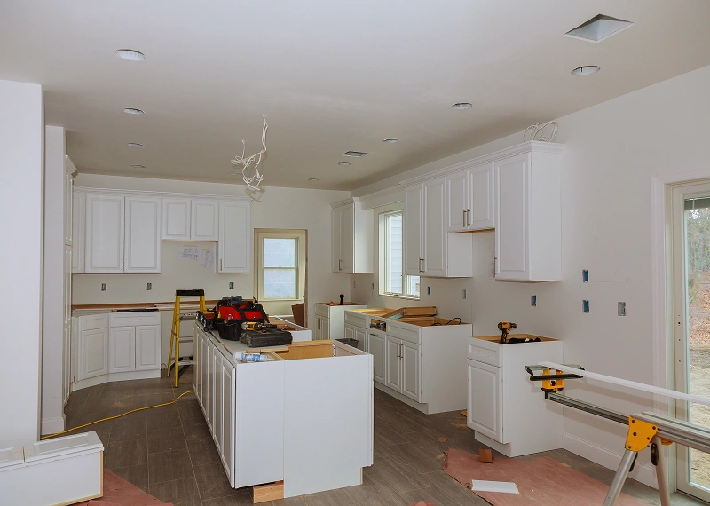 Kitchen under renovation with tools present