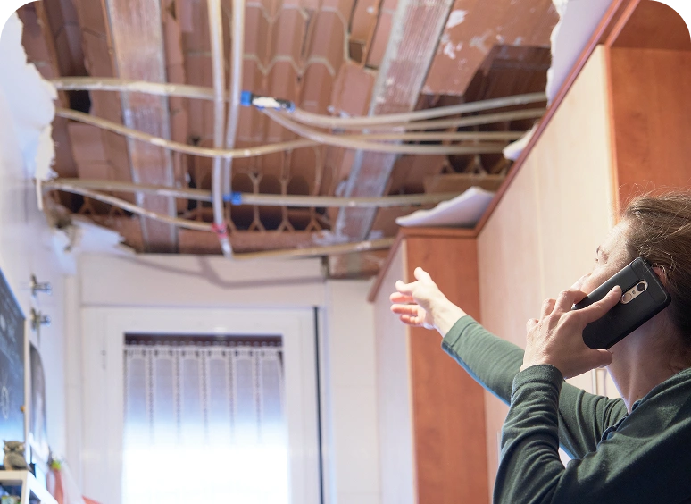 Ceiling water damage with person on phone