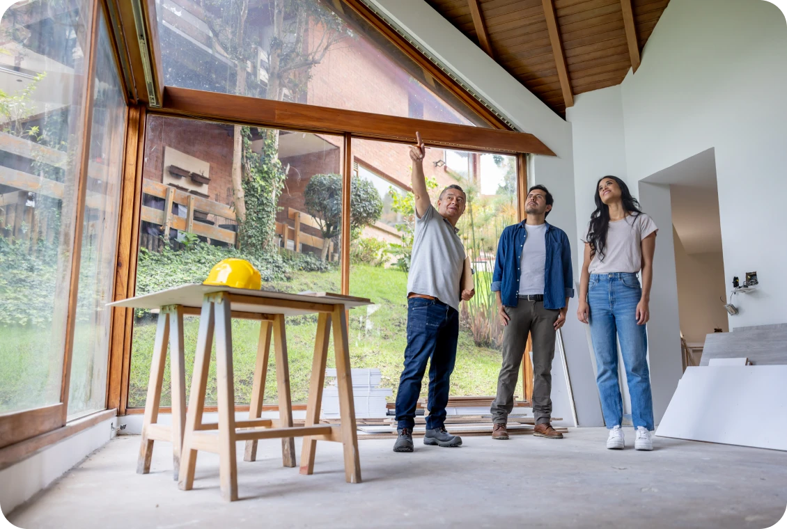 Architect showing house plans to couple