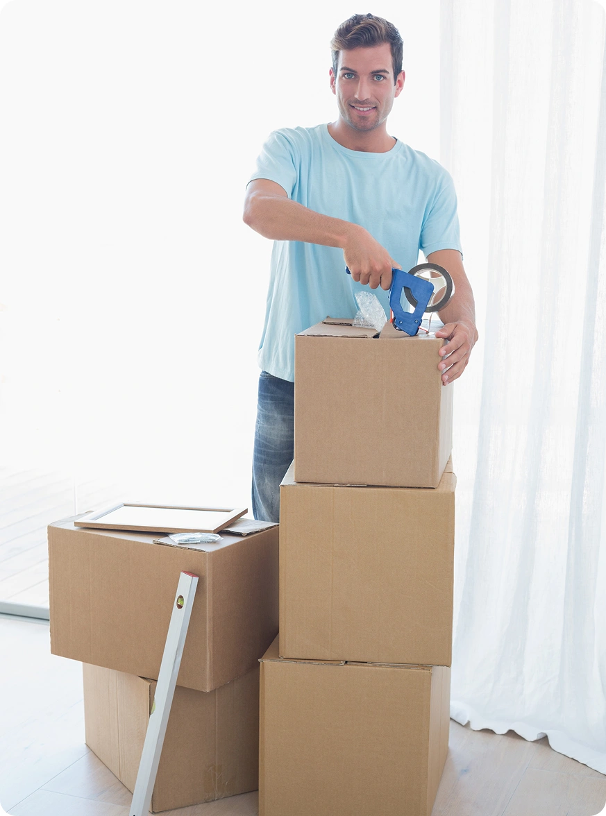Man sealing cardboard boxes with packing tape.